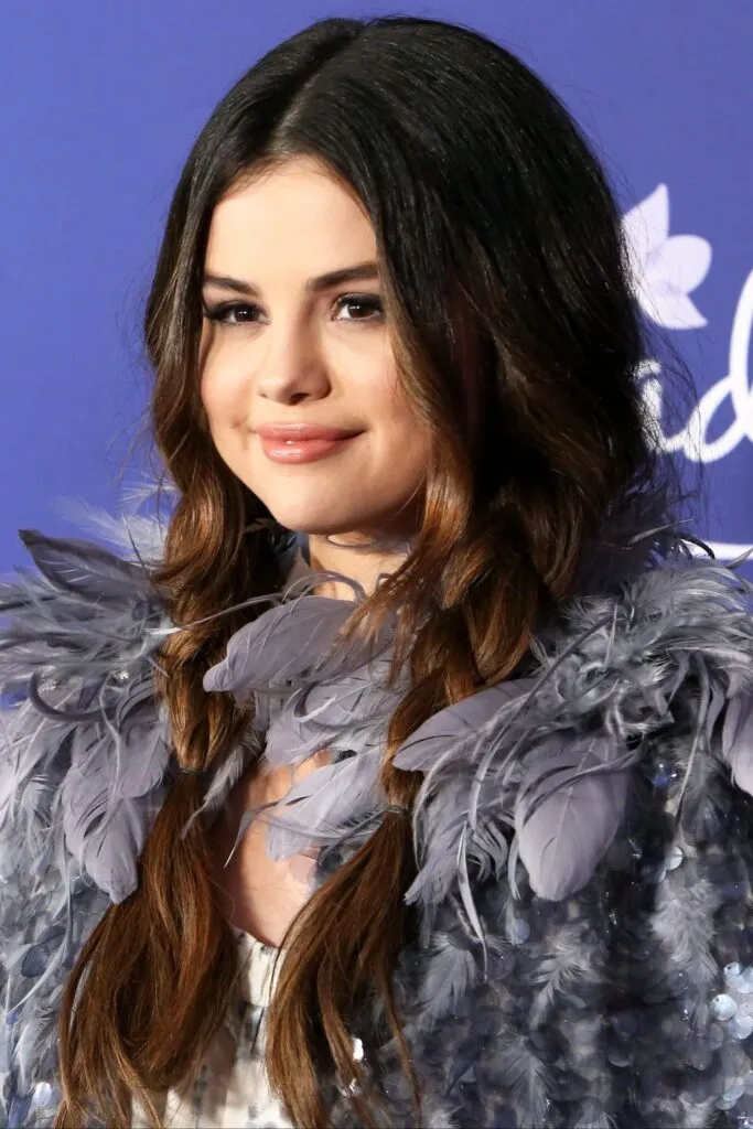 Selena Gomez in grey furry dress posing for camera and showing her Beachy Braids Selena Gomez in grey furry dress posing for camera and showing her Beachy Braids - Beachy Braids