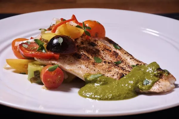 Halibut with Sweet Potato Puree and Chimichurri serves in a white plate Halibut with Sweet Potato Puree and Chimichurri serves in a white plate - bodybuilding dinner meal