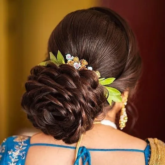 A girl in blue blouse with golden saree posing for camera and showing the back view of her Rose Structured Bun A girl in blue blouse with golden saree posing for camera and showing the back view of her Rose Structured Bun - bun hairstyles