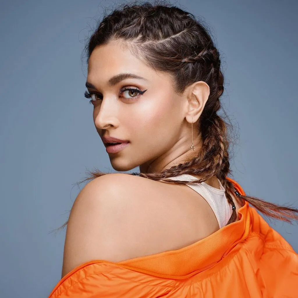 Deepika Padukone in orange jacket with white inner showing the side view of her boxer braids Deepika Padukone in orange jacket with white inner showing the side view of her boxer braids - Deepika Padukone hairstyles