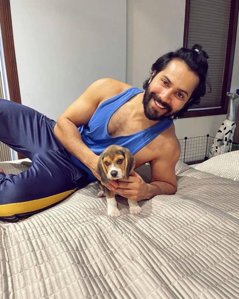 Varun Dhawan in lower and t-shirt with a half tie posing for camera along his puppy Varun Dhawan in lower and t-shirt with a half tie posing for camera along his puppy - bollywwod actors without makeup