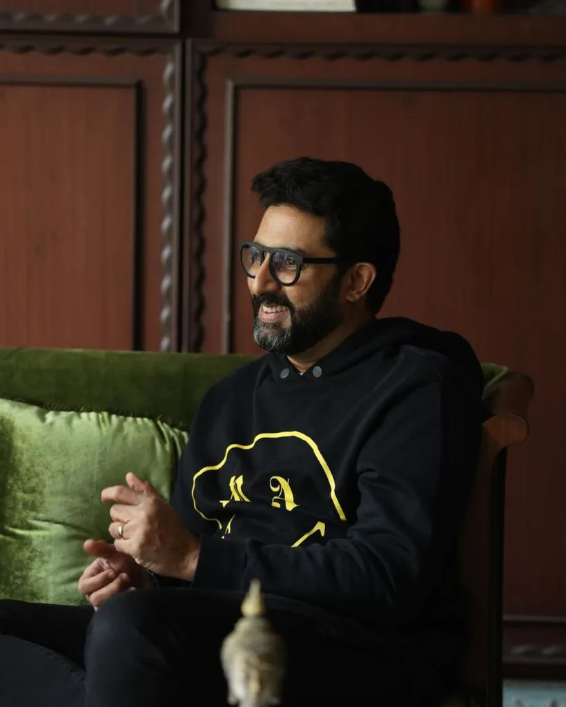 Smiling Abhishek Bachchan in black hoodie and spectacles Smiling Abhishek Bachchan in black hoodie and spectacles - bollywood actors no makeup photos