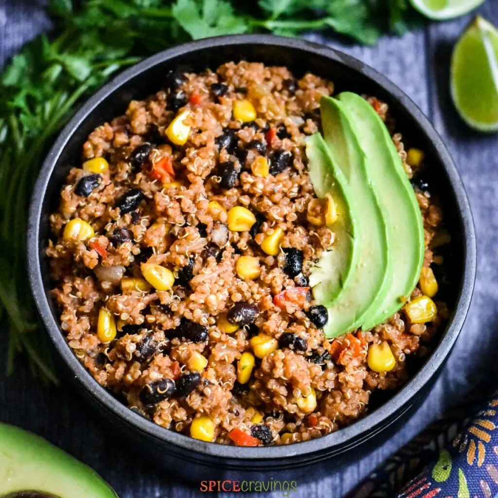 One pan Mexican Quinoa serves in a black bowl One pan Mexican Quinoa serves in a black bowl - great bodybuilding meals