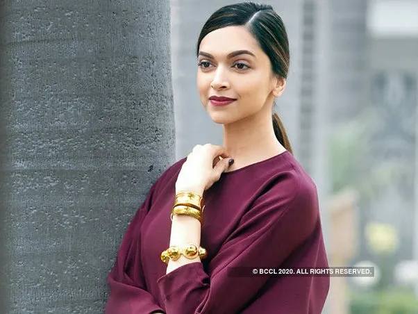 Deepika Padukone in purple dress with golden bracelet posing for camera and showing her Party type Get Straight hair Deepika Padukone in purple dress with golden bracelet posing for camera and showing her Party type Get Straight hair - Deepika Padukone latest hairstyles