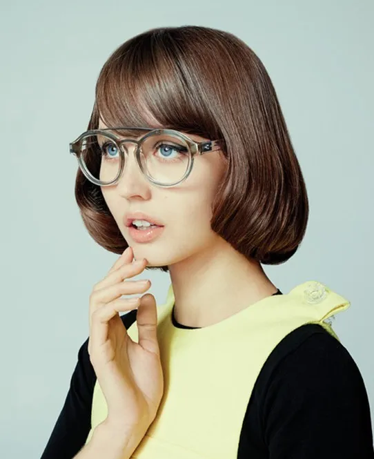 A girl in yellow and black dress with round spectacles showing her Round Edges hairstyle A girl in yellow and black dress with round spectacles showing her Round Edges hairstyle - short hair cuts fir girls