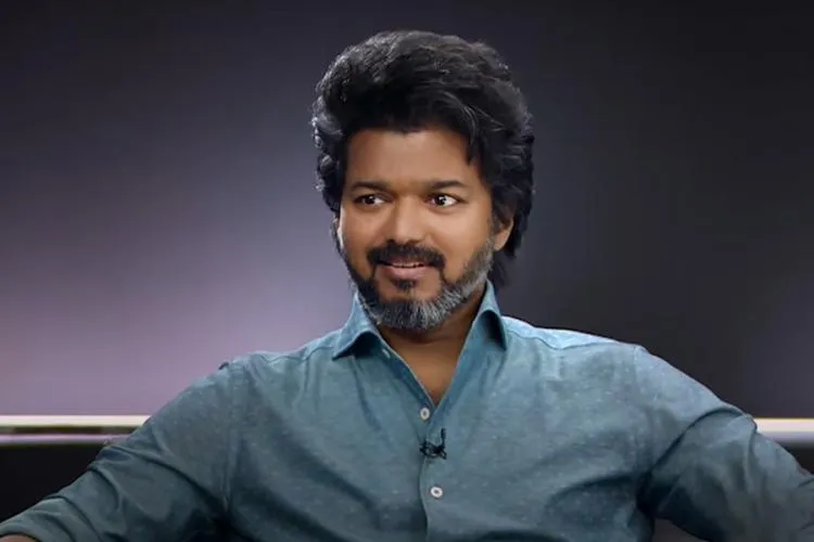 Joseph Vijay in blue shirt sitting on couch Joseph Vijay in blue shirt sitting on couch - south Indian actors without makeup