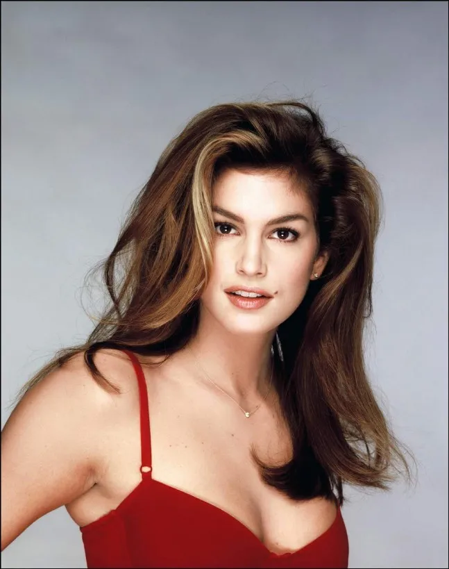Cindy Crawford in red bikini top posing for camera - celebrities who got lasik surgery