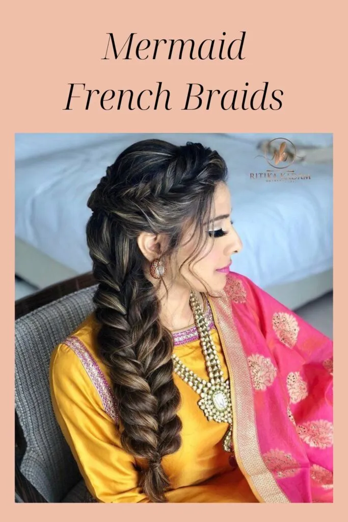 A women in red and pink traditional suit with jewellery showing her Mermaid French Braids A women in red and pink traditional suit with jewellery showing her Mermaid French Braids - Indian Hairstyles 2022