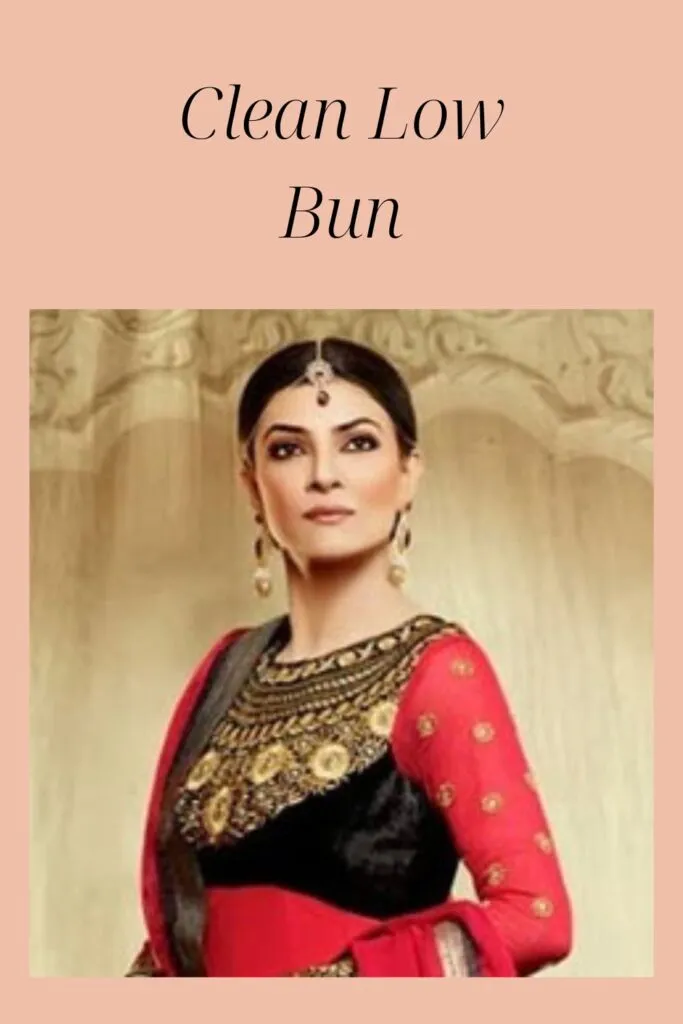 Sushmita Sen in red and black traditional outfit with matching jewellery showing her clean low bun Sushmita Sen in red and black traditional outfit with matching jewellery showing her clean low bun - latest Indian women hairstyles