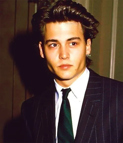 Johnny Depp in black leather jacket posing for camera and showing his long hairstyle Johnny Depp Popular hairstyles - Johnny Depp Young look hairstyle