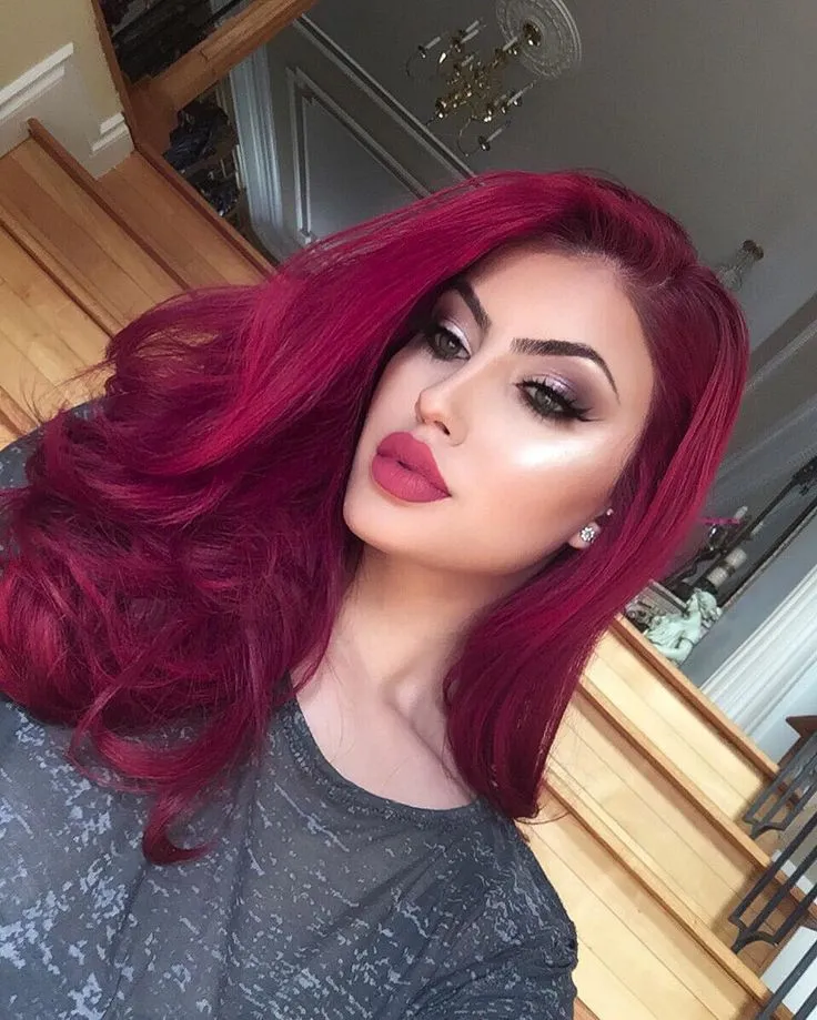 Top 141+ Red Hair Color Styles, You Can Follow 2023 11 A girl in grey printed t-shirt with pink lipstick showing her red hair color - red hair color with highlights