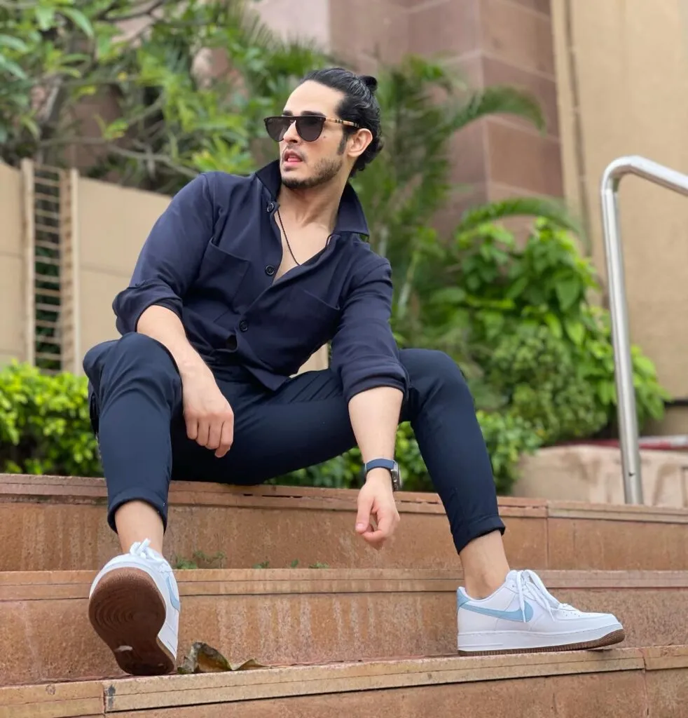 Priyank Sharma in all blue outfit with white sneakers and goggles posing for camera Priyank Sharma in all blue outfit with white sneakers and goggles posing for camera - top 10 hindi serial actors 2022