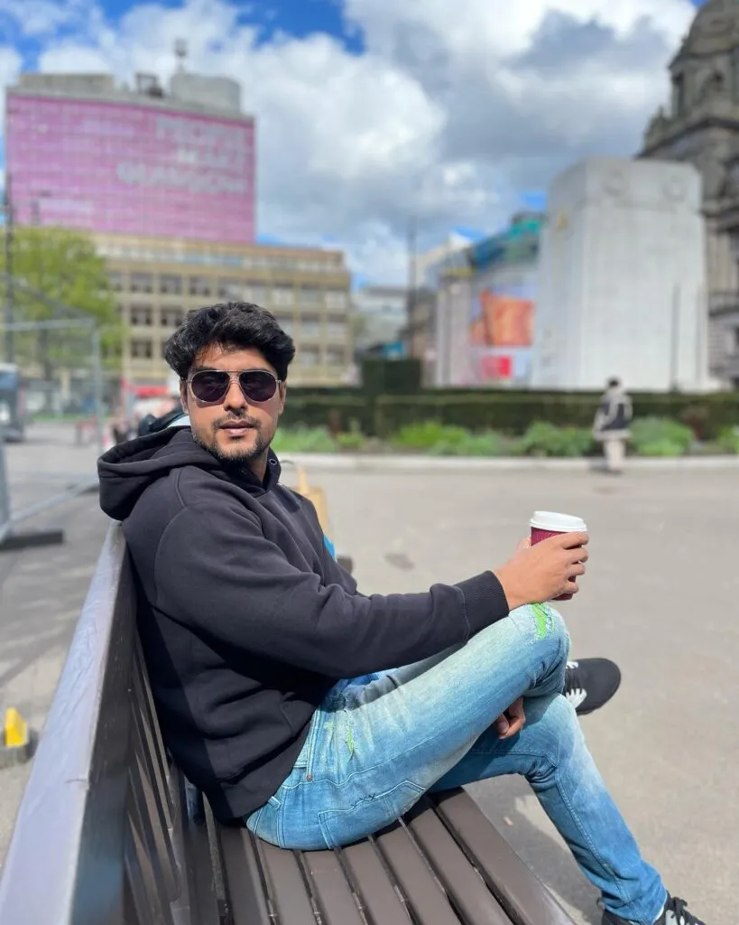 Ankit Gupta in black hoodie with blue jeans and goggles sitting on a bench holding a cup of coffee Ankit Gupta in black hoodie with blue jeans and goggles sitting on a bench holding a cup of coffee - most handsome tv actors indian