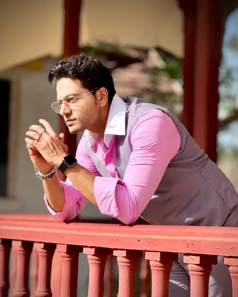 Gaurav Khanna in pink shirt with grey waist coat and spectacles posing for camera Gaurav Khanna in pink shirt with grey waist coat and spectacles posing for camera - hottest actor on indian television