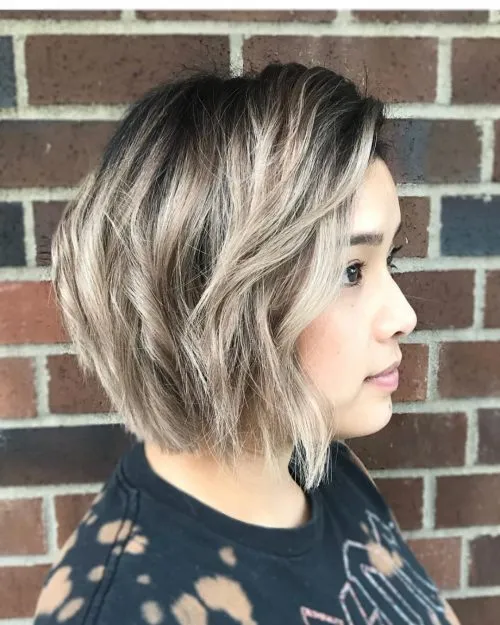 A women in black printed top showing the side view of her Chic Chin-length Bob hairstyle - Short hairstyles for American women