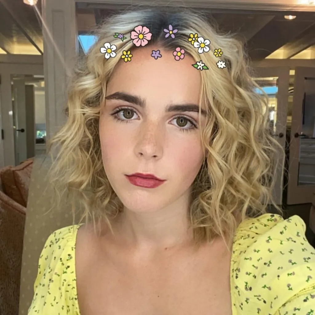 Kiernan Shipka in yellow printed dress posing for camera - hollywood short hair actress