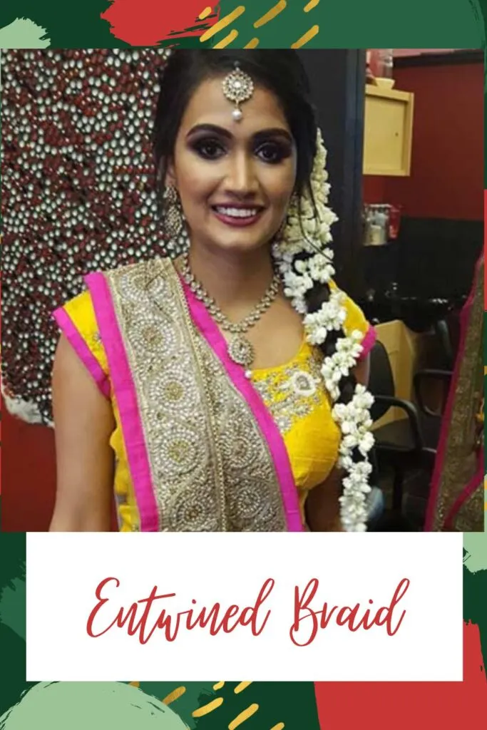 A girl in pink and yellow lehenga posing for camera and showing her Entwined Braid A girl in pink and yellow lehenga posing for camera and showing her Entwined Braid - Traditional hairstyles for Indian women