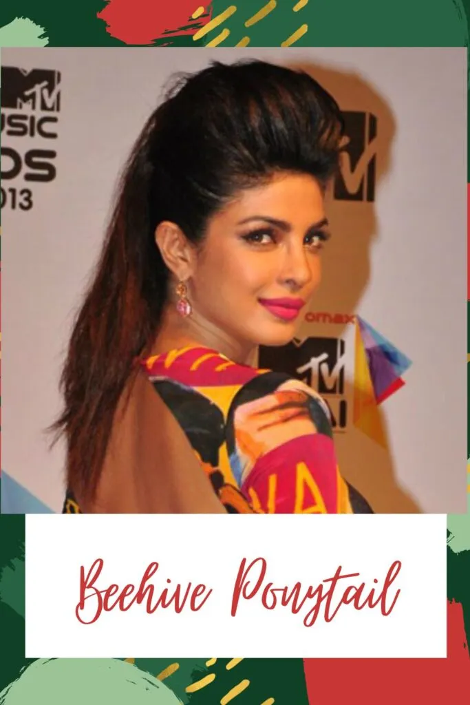 A girl in multicolor backless dress with pink drop earrings posing for camera and showing her Beehive Ponytail A girl in multicolor backless dress with pink drop earrings posing for camera and showing her Beehive Ponytail - Hairstyles for Indian Women