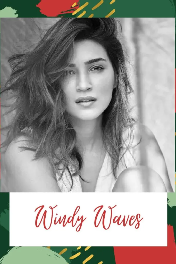 A girl in white tank top sitting and showing her windy waves hairstyle A girl in white tank top sitting and showing her windy waves hairstyle - Haircuts for Indian Women