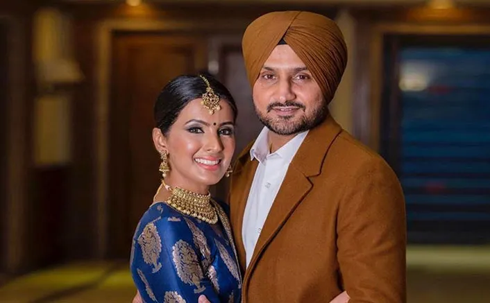 Harbhajan Singh and Geeta Basra in traditional outfit posing for camera Harbhajan Singh and Geeta Basra in traditional outfit posing for camera - wives of indian cricketers