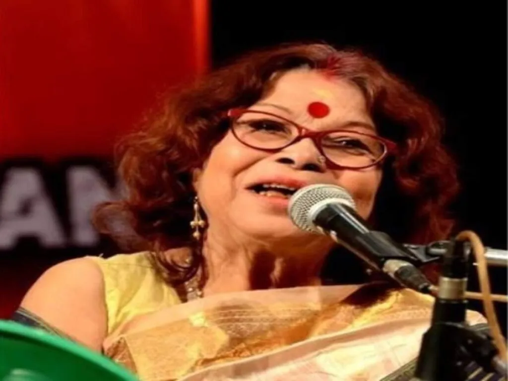 Nirmala Sharma in white and golden saree speaking on mic Nirmala Sharma in white and golden saree speaking on mic - indian celebrities who died in 2022