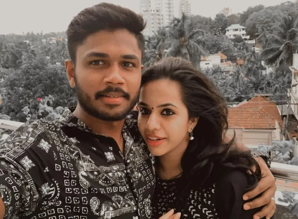 Sanju Samson and Charulatha Samson in matching black outfit posing for a selfie Sanju Samson and Charulatha Samson in matching black outfit posing for a selfie - indian cricketers wife photos