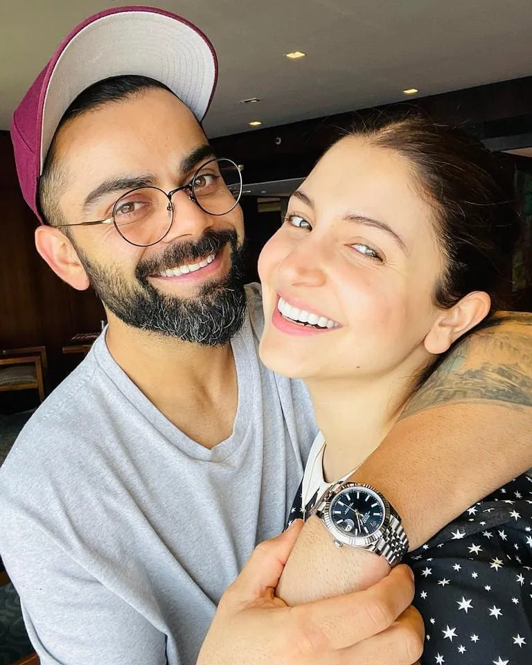 Smiling Virat Kohli and Anushka Sharma posing for a selfie Smiling Virat Kohli and Anushka Sharma posing for a selfie - indian cricket team and their wives