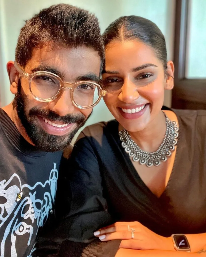 Smiling Jasprit Bumrah in spectacles and Sanjana Ganesan posing for a selfie Smiling Jasprit Bumrah in spectacles and Sanjana Ganesan posing for a selfie - indian cricketers wife
