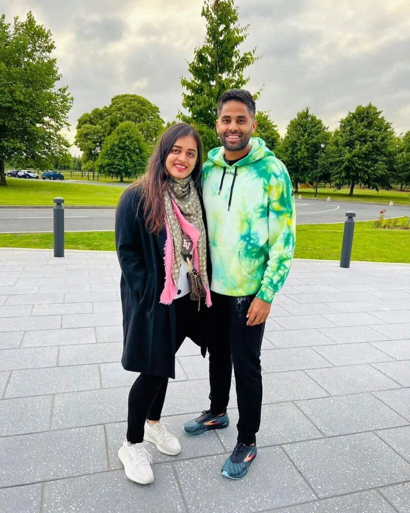 Surya Kumar Yadav in multicolor hoodie and Devisha Shetty in multi color scarf Surya Kumar Yadav in multicolor hoodie and Devisha Shetty in multi color scarf - indian cricket team and their wives