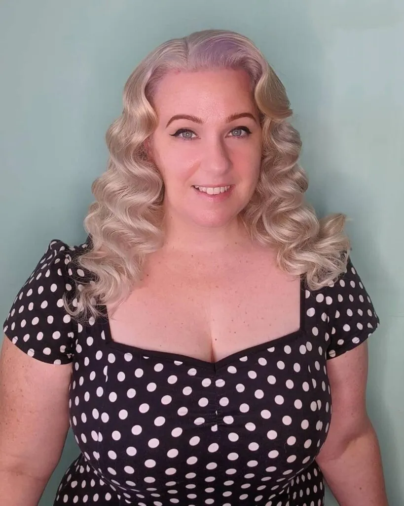 Woman in black and white polka dots dress with Retro curls - 2022 haircuts female