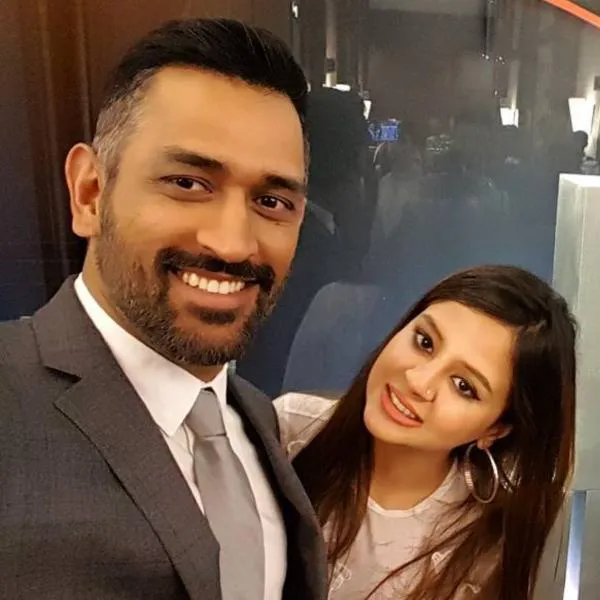 Smiling MS Dhoni and Sakshi Singh Dhoni posing for a selfie Smiling MS Dhoni and Sakshi Singh Dhoni posing for a selfie - indian cricketers and their wives
