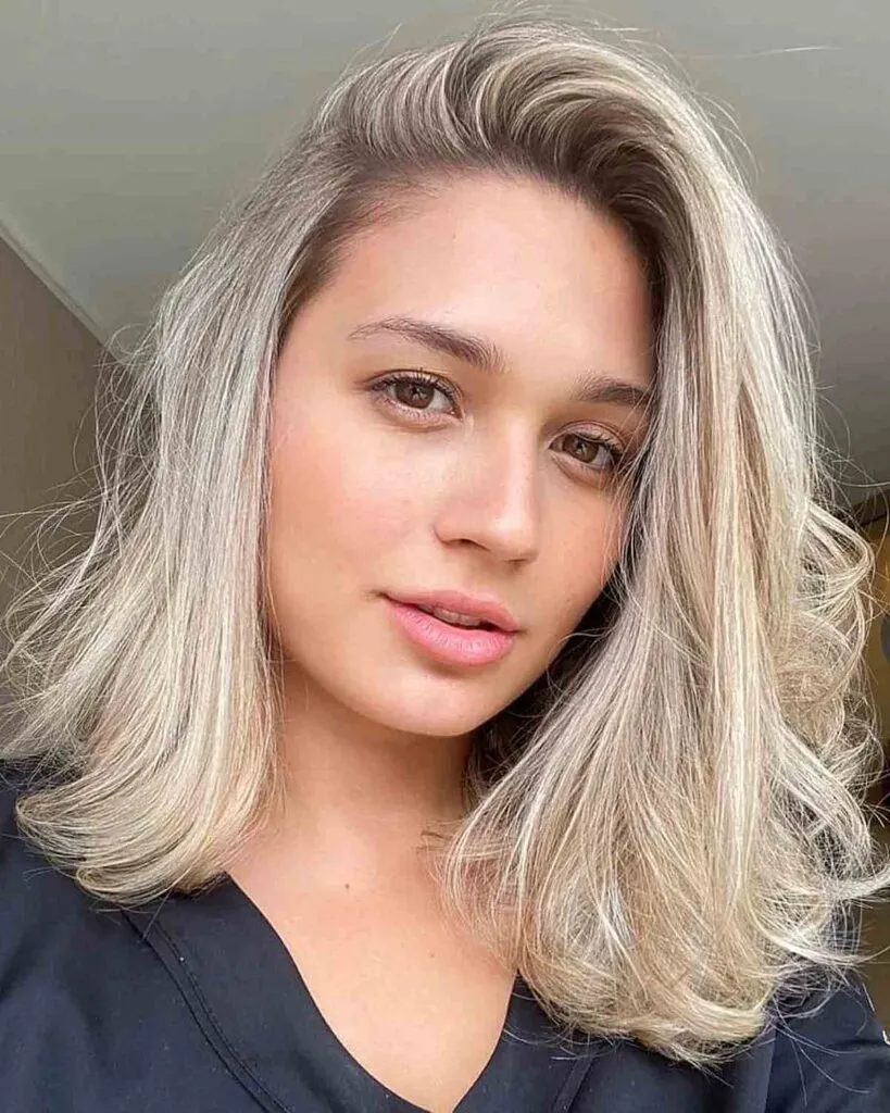 Woman in black dress and Deep side apart hairstyle - 2022 trendy haircuts