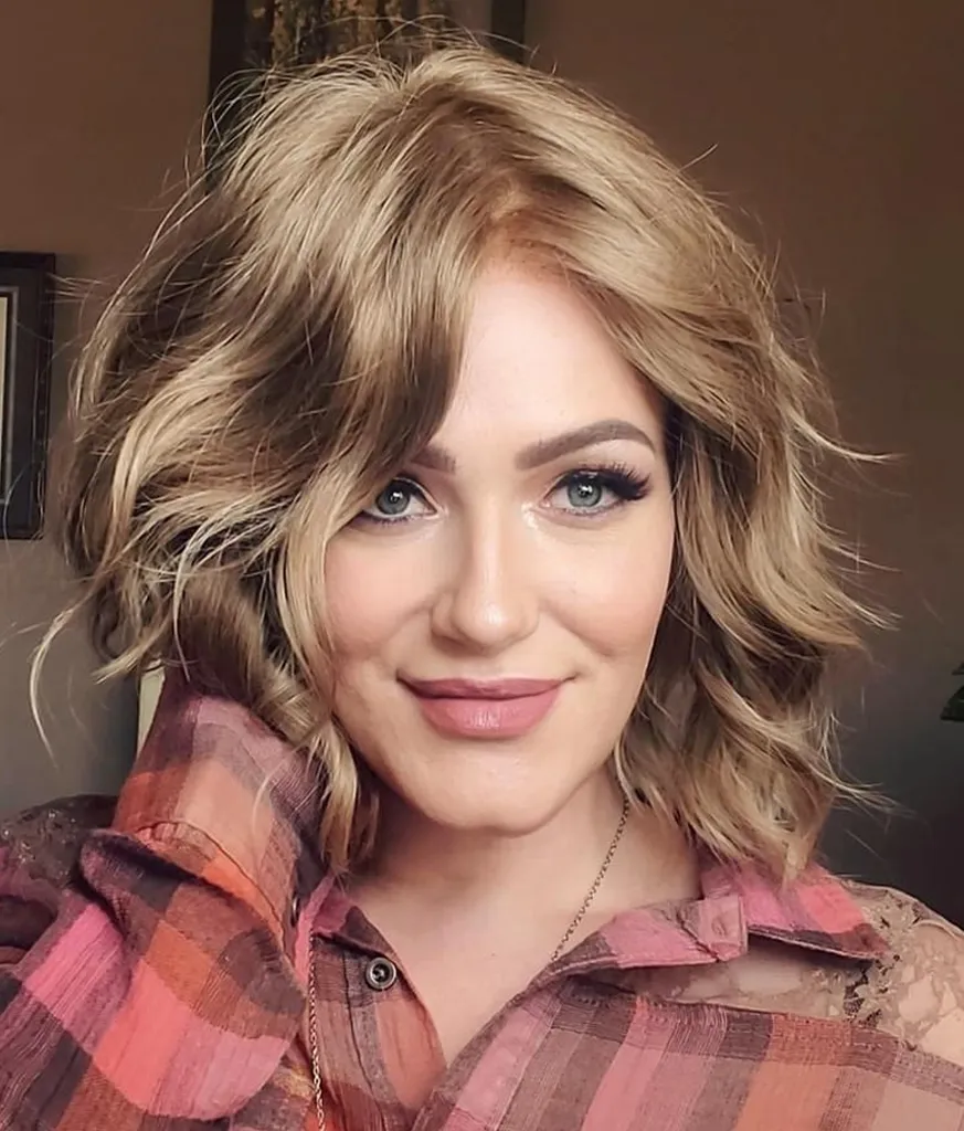 Woman in pink check shirt showing her Shoulder Length Shag for Thick Hair