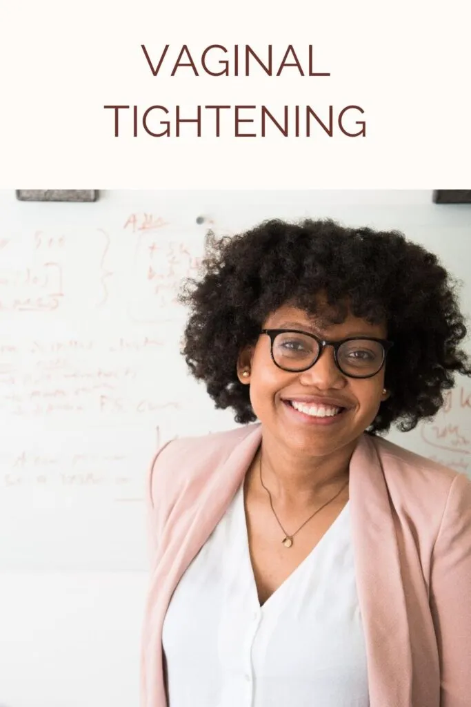 Smiling woman in pink coat with white shirt and spectacles - Vaginal Tightening 