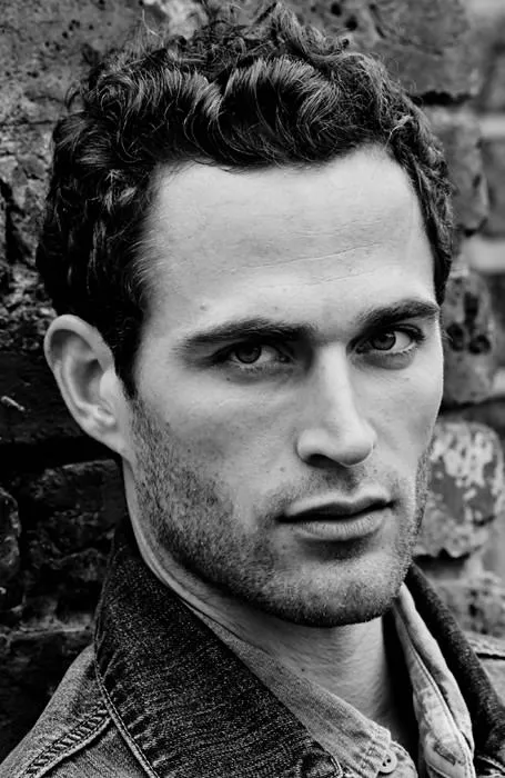 man in denim jacket and Short Curls hairstyle - haircuts for men medium