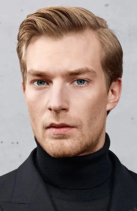 Man in high neck neck pullover and coat with Side Part with Quiff hairstyle - haircuts for men with beards