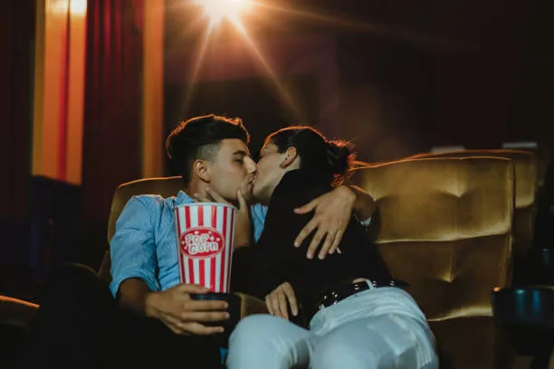 Couple kissing in the movie theater Couple kissing in the movie theater - places to make out