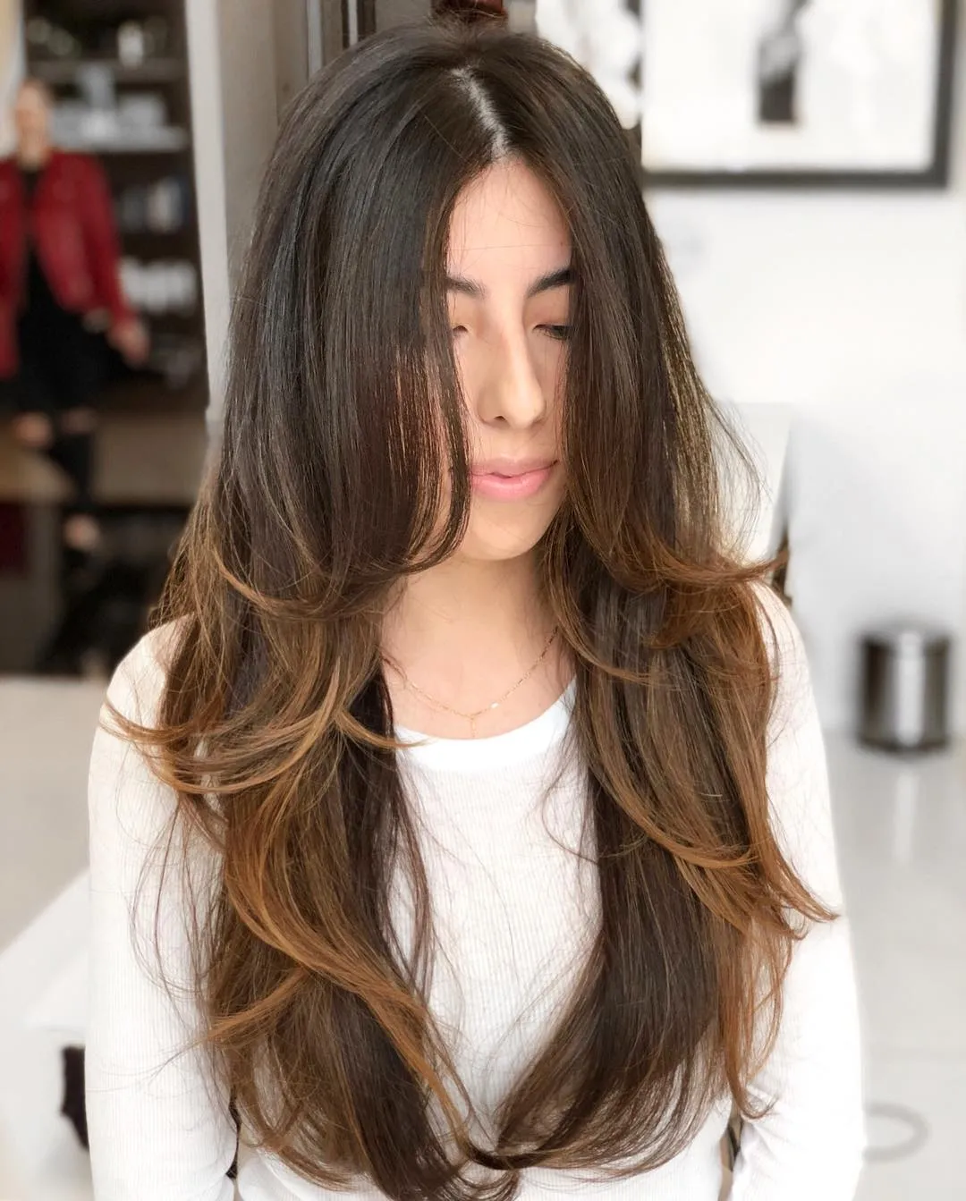 Woman in white full sleeves top with Face Framing Layers hairstyle Woman in white full sleeves top with Face Framing Layers hairstyle - hair cut for girls long hair