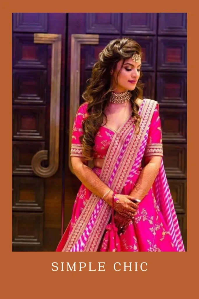 Woman in pink lehenga with matching jewellery and Simple Chic hairstyle Woman in pink lehenga with matching jewellery and Simple Chic hairstyle - Curly Hairstyles for lehenga