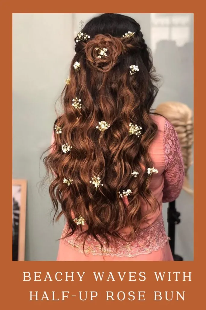 Woman in pink lehenga showing the back view of her Beachy Waves with half-up Rose Bun hairstyle Woman in pink lehenga showing the back view of her Beachy Waves with half-up Rose Bun hairstyle - lehenga hairstyles for curly hair