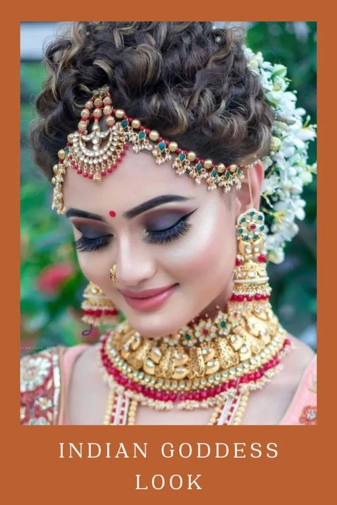 Woman in multicolor golden jewellery with gajra bun and flaunting her Indian Goddess Look Woman in multicolor golden jewellery with gajra bun and flaunting her Indian Goddess Look - Hairstyle with lehenga for medium hair